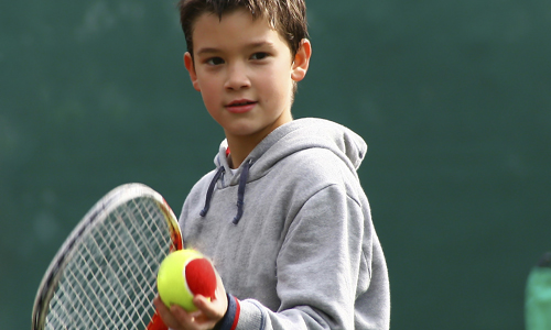 Boy playing tennis